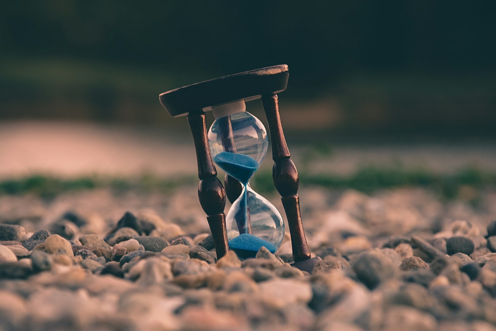 Hourglass on stones symbolizing time efficiency